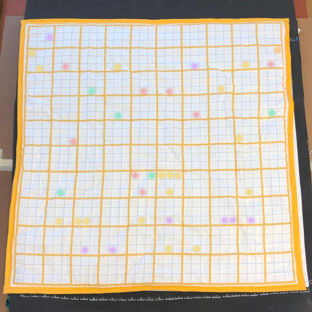 A photo of the completed Floor Chart. LEDs in a variety of colors illuminate a smattering of squares across the chart.
