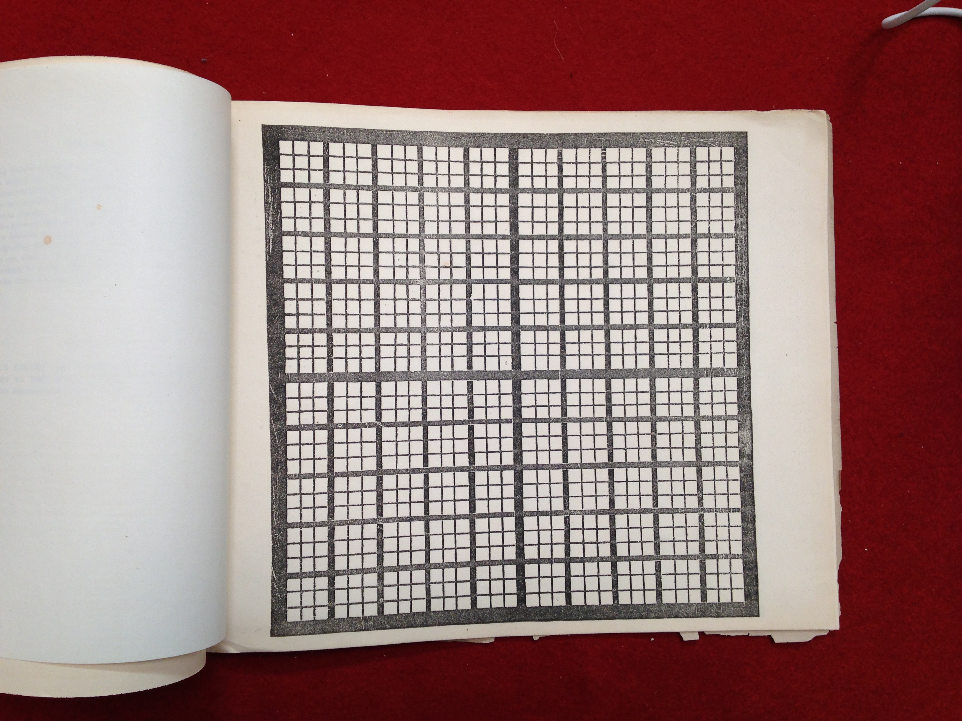 A photo of a blank chart from a page of Peabody’s workbooks, set against a red backdrop.